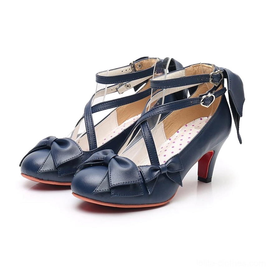 Dark blue cross-strap sweet Lolita Mary Jane heels worn from front-facing angle showing crisscross strap design and red high heel