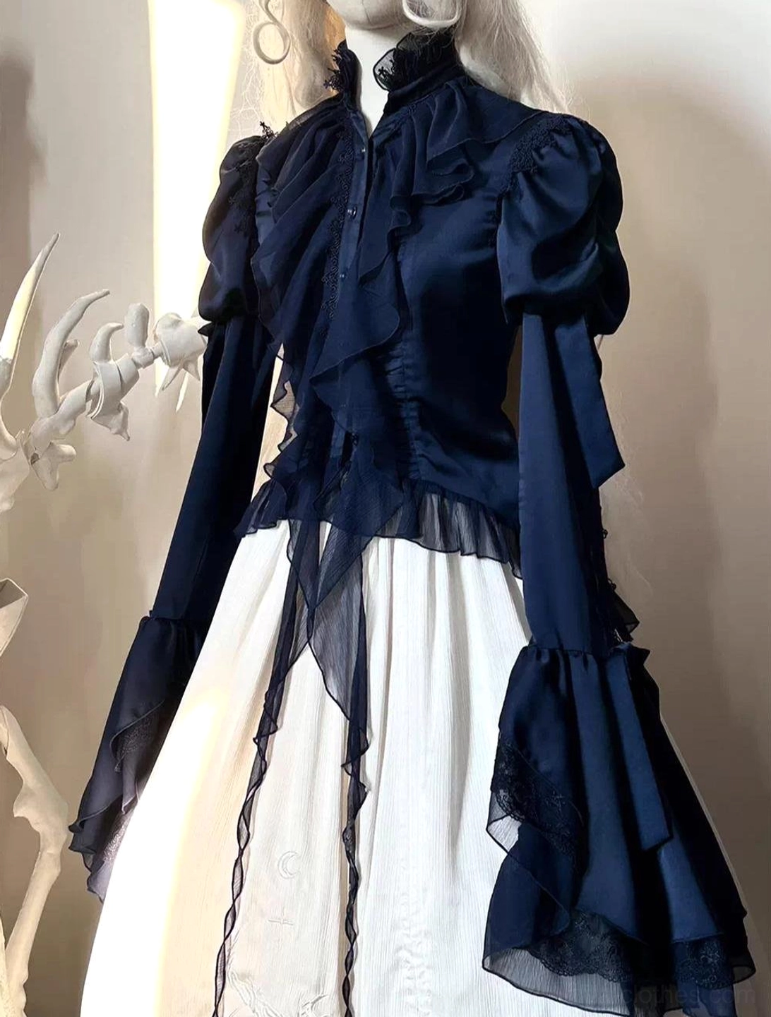 Dark blue gothic lolita blouse with juliet sleeves and irregular swallowtail flounce hem, displayed on mannequin showing front view with ruffled stand collar and lace trims