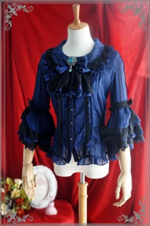 Dark blue tiered lace Peter Pan collar Lolita blouse with gem-set bow brooch, black lace ruffled bell sleeves, front button closure, and striped sheer chiffon fabric on dress form