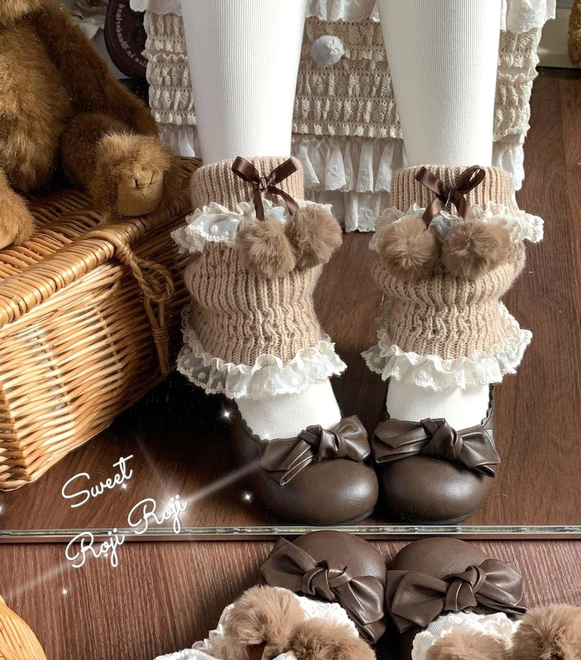 Dark brown knitted lolita leg warmers featuring bow embellishments, fuzzy pom-pom decorations, lace frilled cuffs, wool knitted texture on model