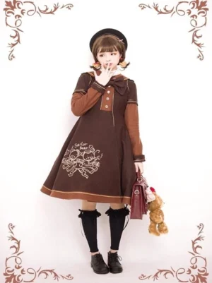 Dark brown sailor lolita overcoat with detachable bow, bear embroidery on A-line skirt hem, white contrast trim details, full-body frontal view with vintage props and styling