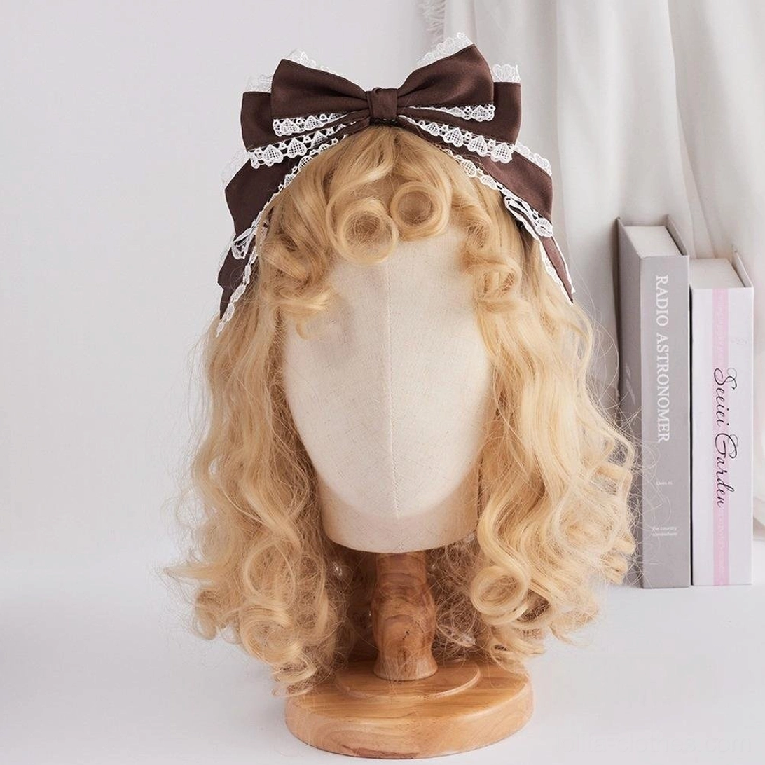 Dark brown satin sweet lolita bow headdress with white scalloped lace trim front view on blonde wig display mannequin