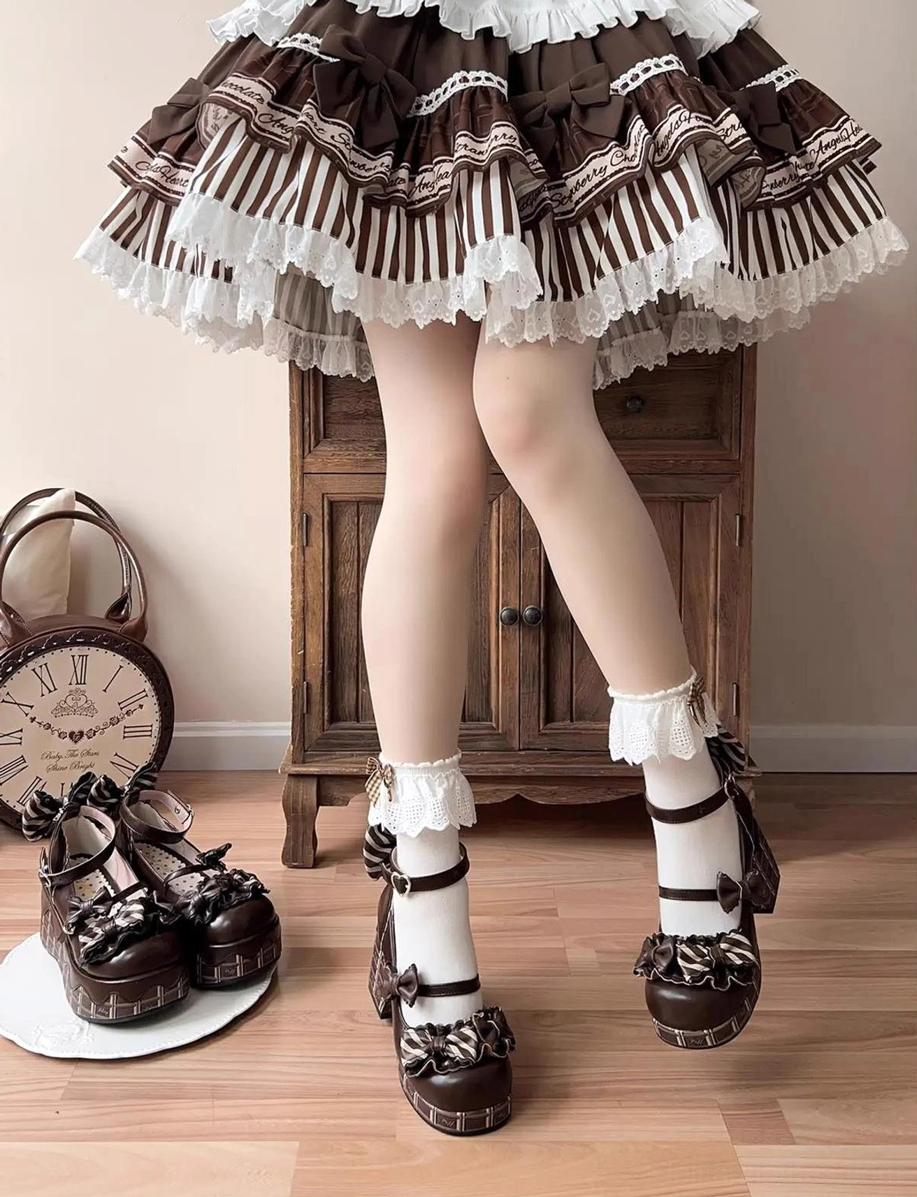 Full lower body model view of dark chocolate sweet lolita heels with white ruffled socks paired with striped ruffled lolita skirt
