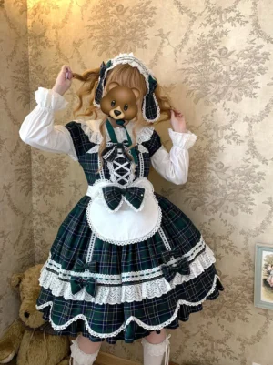 Dark green tartan plaid Old School Lolita accessory ensemble featuring bunny ear headdress, layered lace apron and matching bows on model in vintage room setting