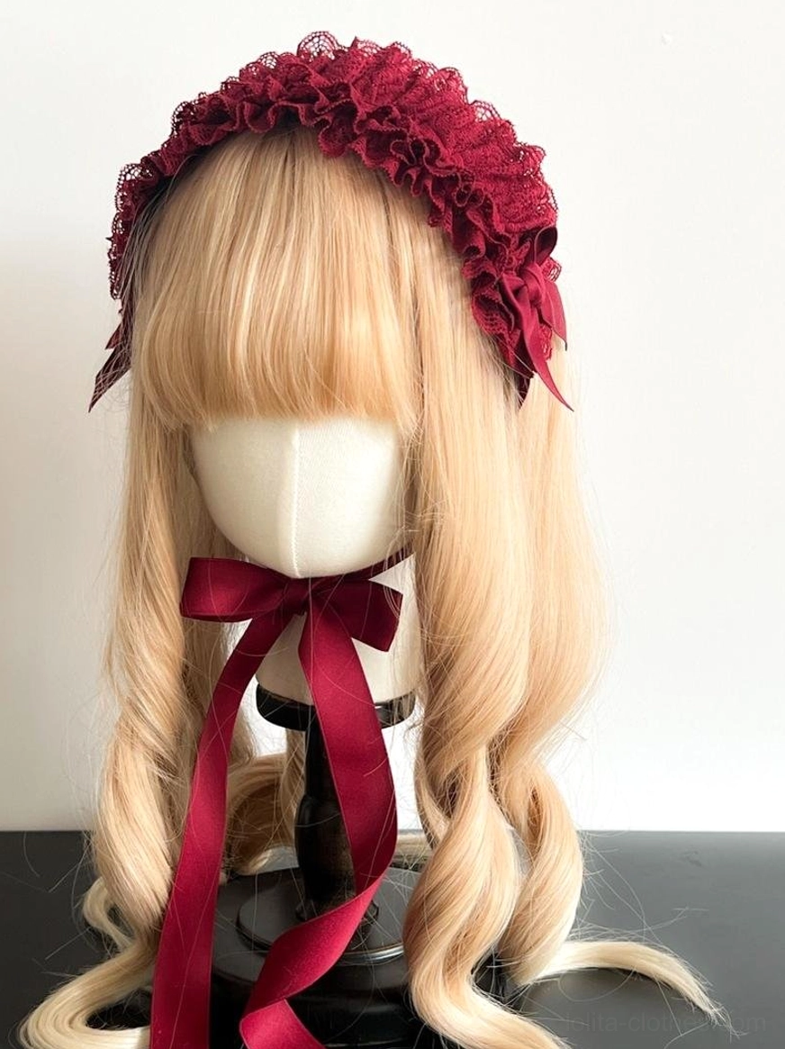 Deep purple lace KC headdress on mannequin with brown twin ponytails, featuring dark regal purple ruffled lace and matching satin bow details