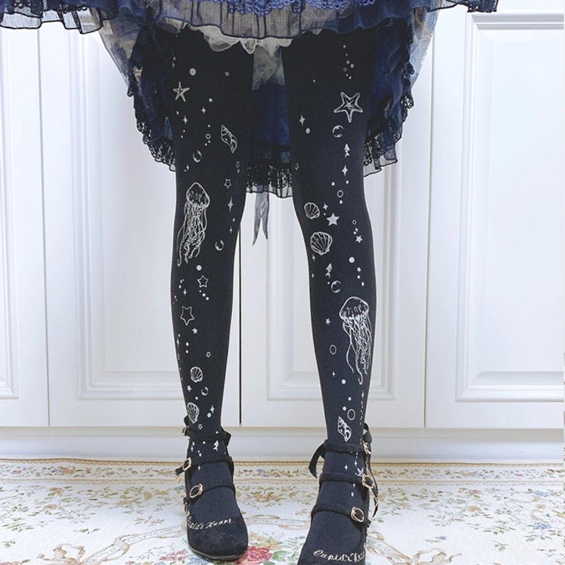 Black Deep Sea Jellyfish 120D velvet Lolita tights featuring oceanic jellyfish and star print design, paired with dark blue frilled Lolita skirt and black leather loafers for classic Lolita styling