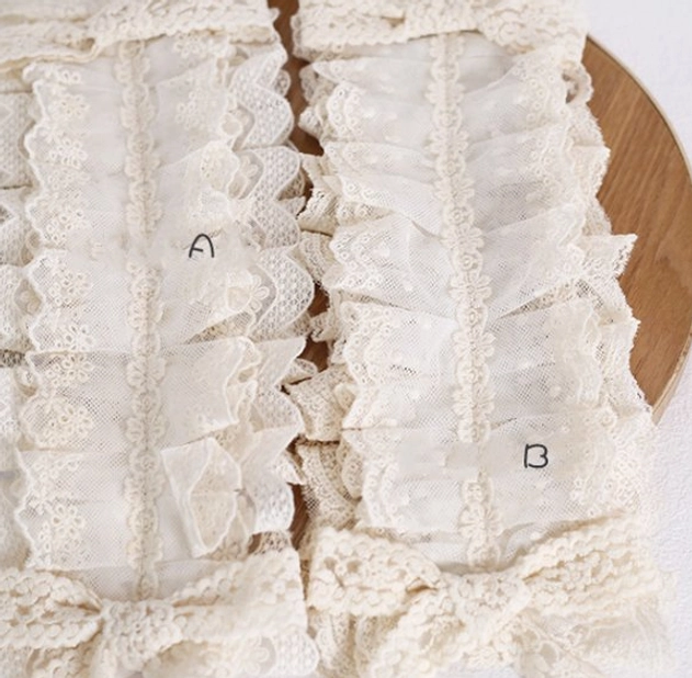 Detailed lolita lace headdress components close-up flat lay view on wooden base, showing two style options A and B, sheer mesh lace base with ruffled edges and bottom bow lace trim details