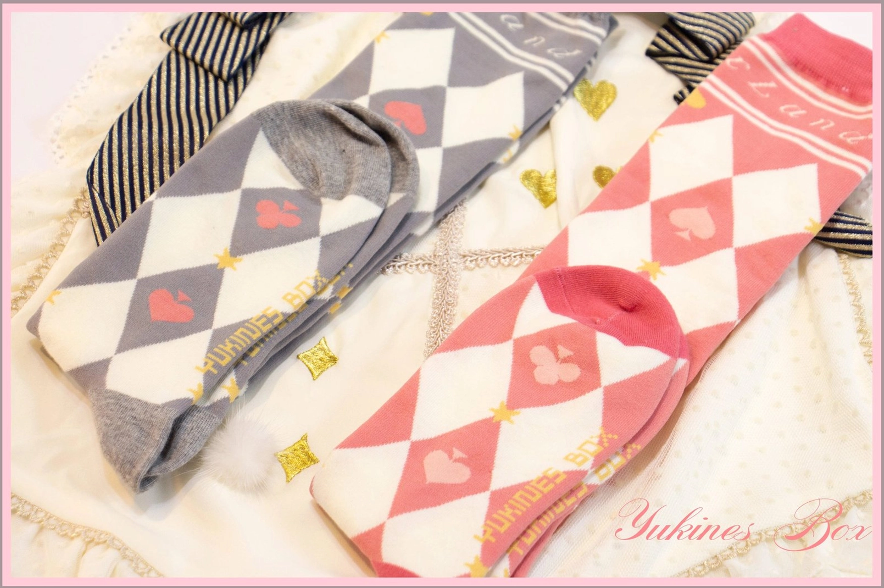 Close up top down flat lay view two styles diamond pattern pink gray and pink white checkerboard heart poker print lolita cotton socks