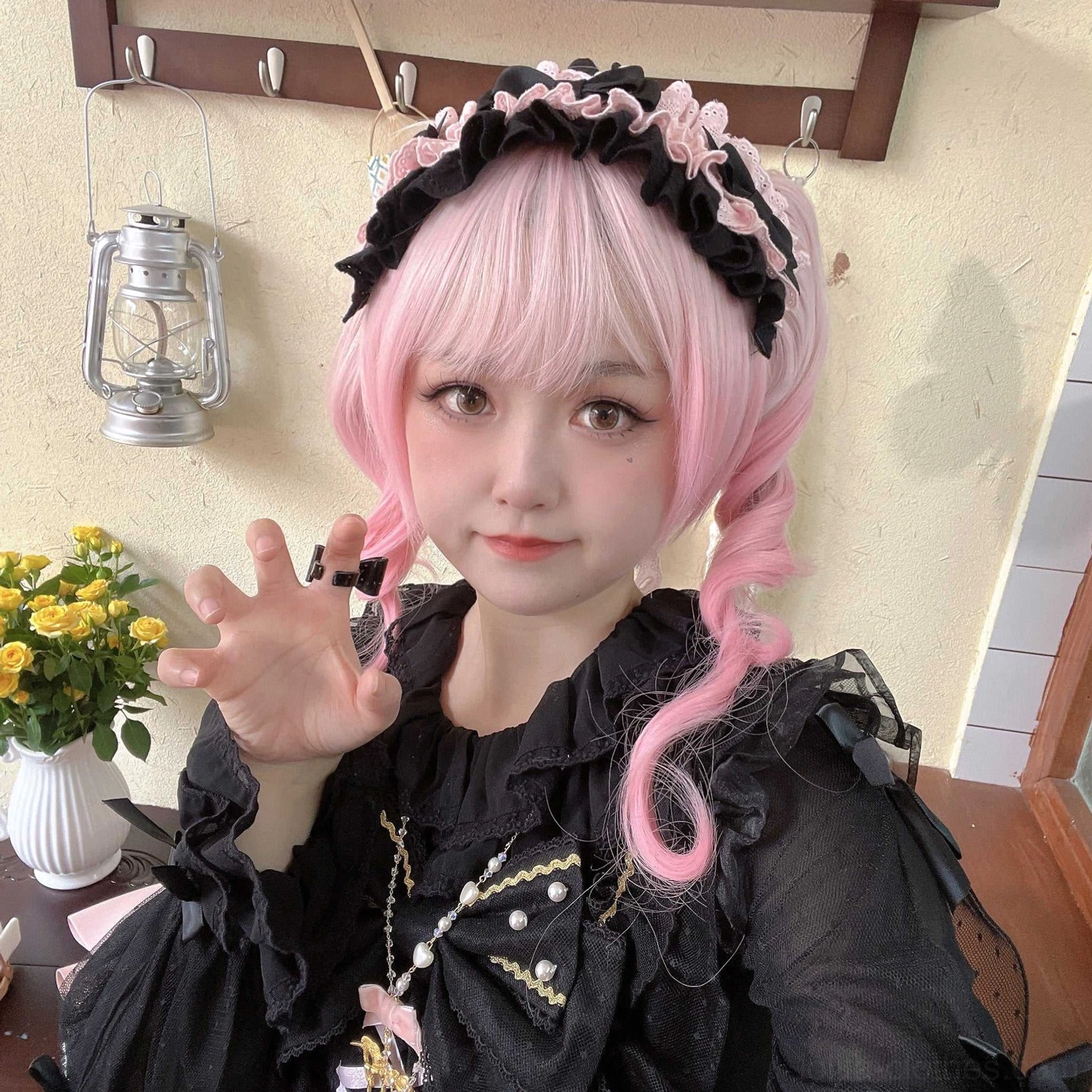 Black cotton lolita headdress with full-body coordinate on pink wig model in outdoor grassy area wearing tiered ruffled skirt with gold trim and light purple satin bow accent details