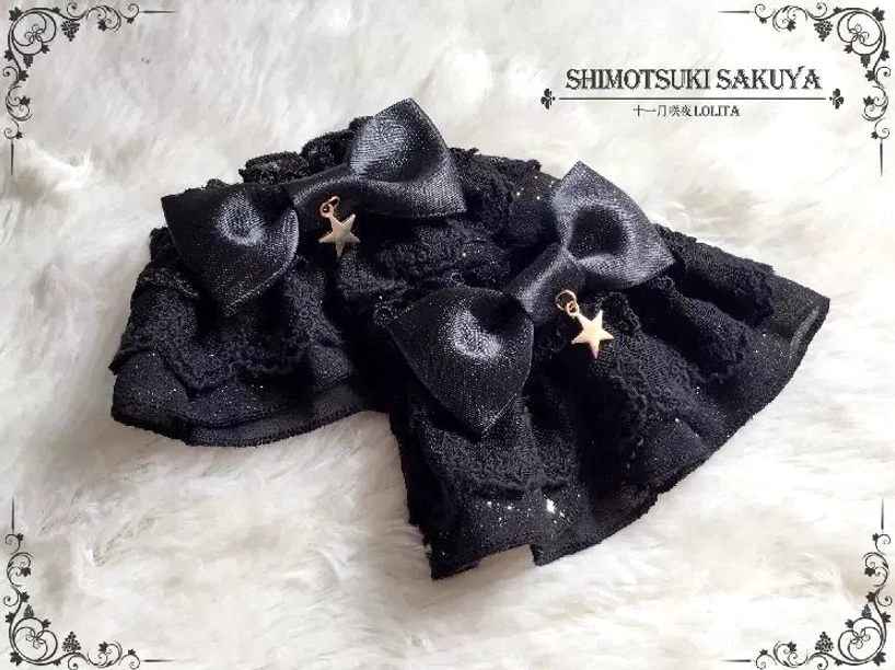Double-layer black vintage Lolita bow hair clips set with glittery ruffled lace trim and star charm accents flat lay display