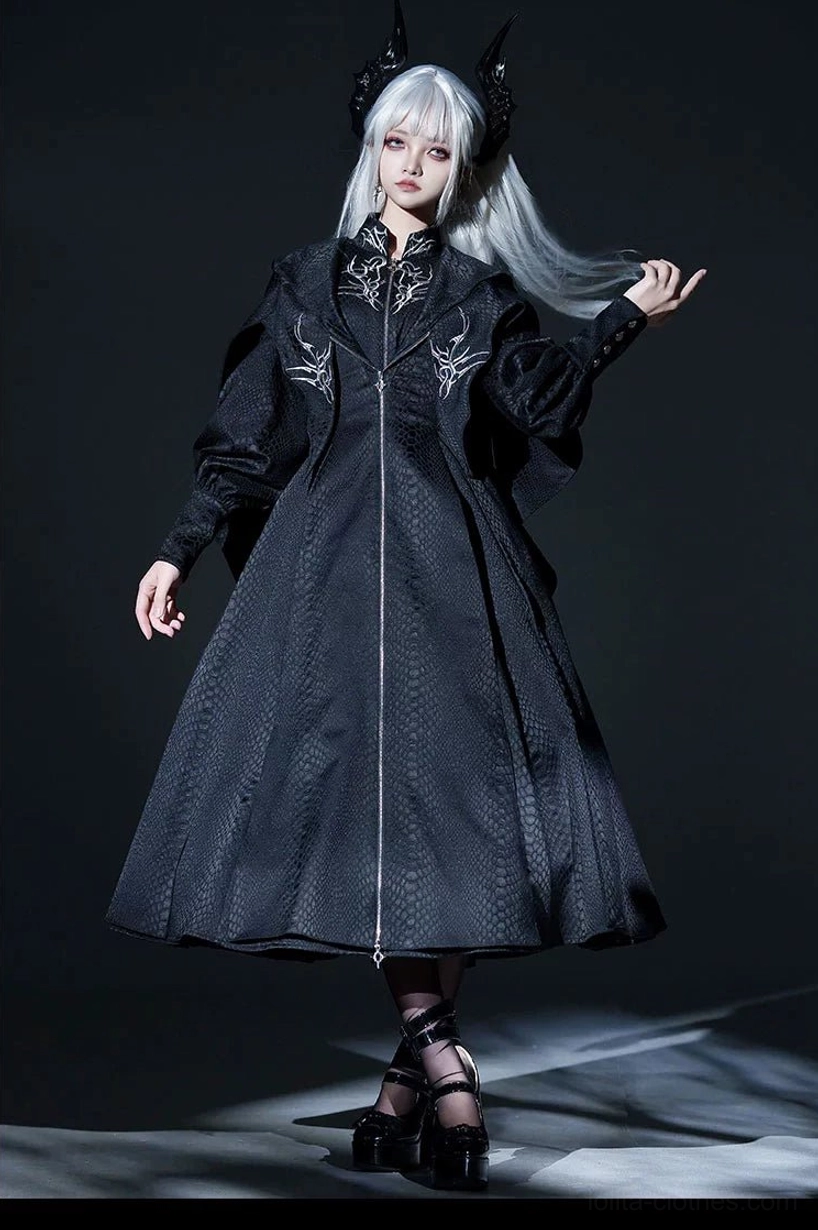 Black Gothic long coat with silver embroidered collar and front zipper detail on model wearing horn headpiece