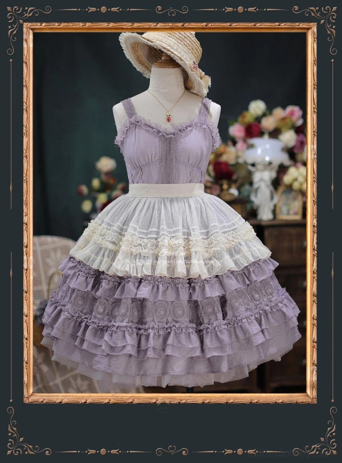 Lavender purple lolita JSK with detachable lace apron overlay and tiered ruffled skirt with lace trims, mannequin accessorized with pendant necklace and straw boater hat in vintage setting