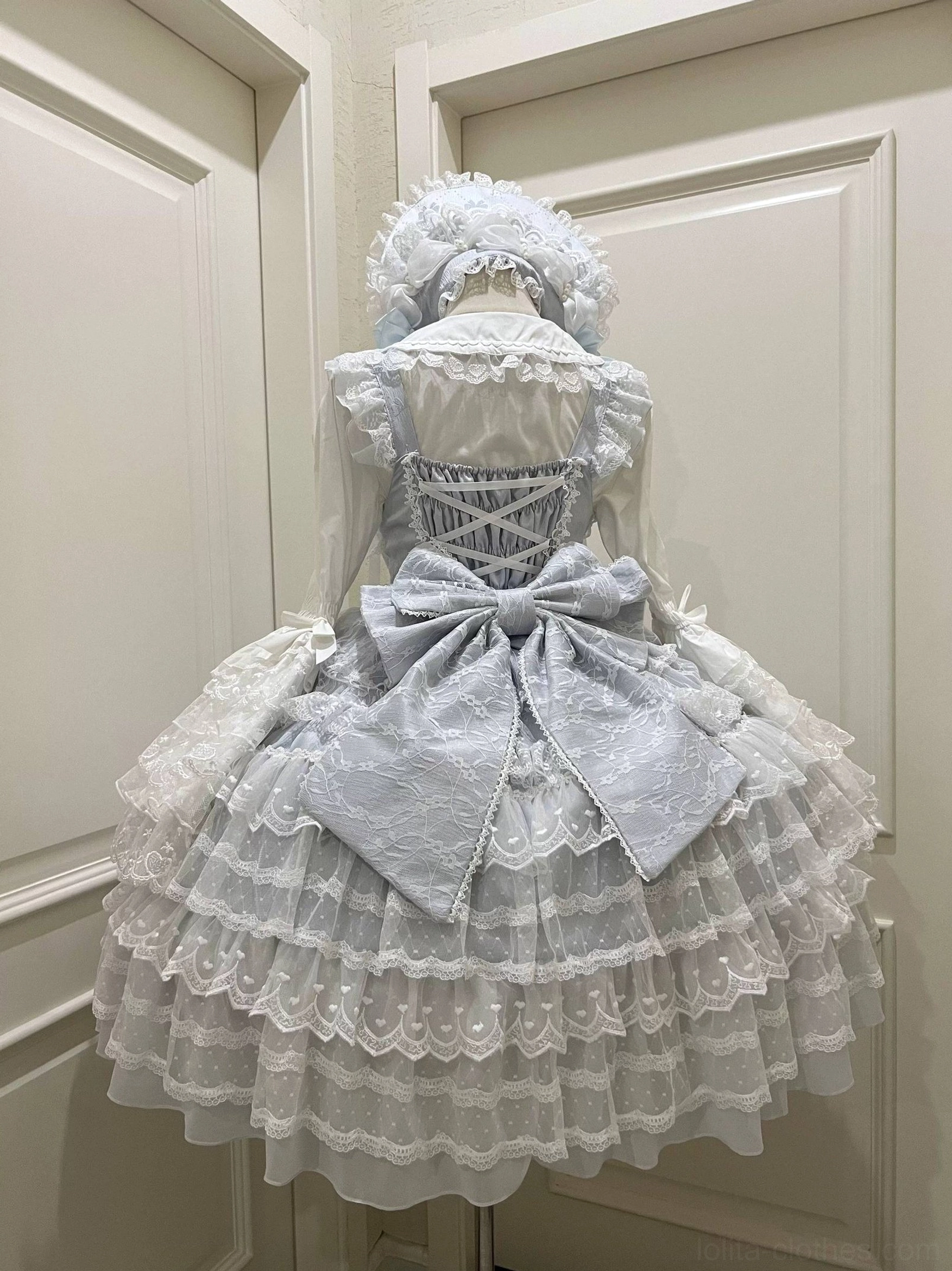 Sky blue Lolita JSK dress suit showing lace-up corset back oversized back bow and layered ruffle lace skirt rear view