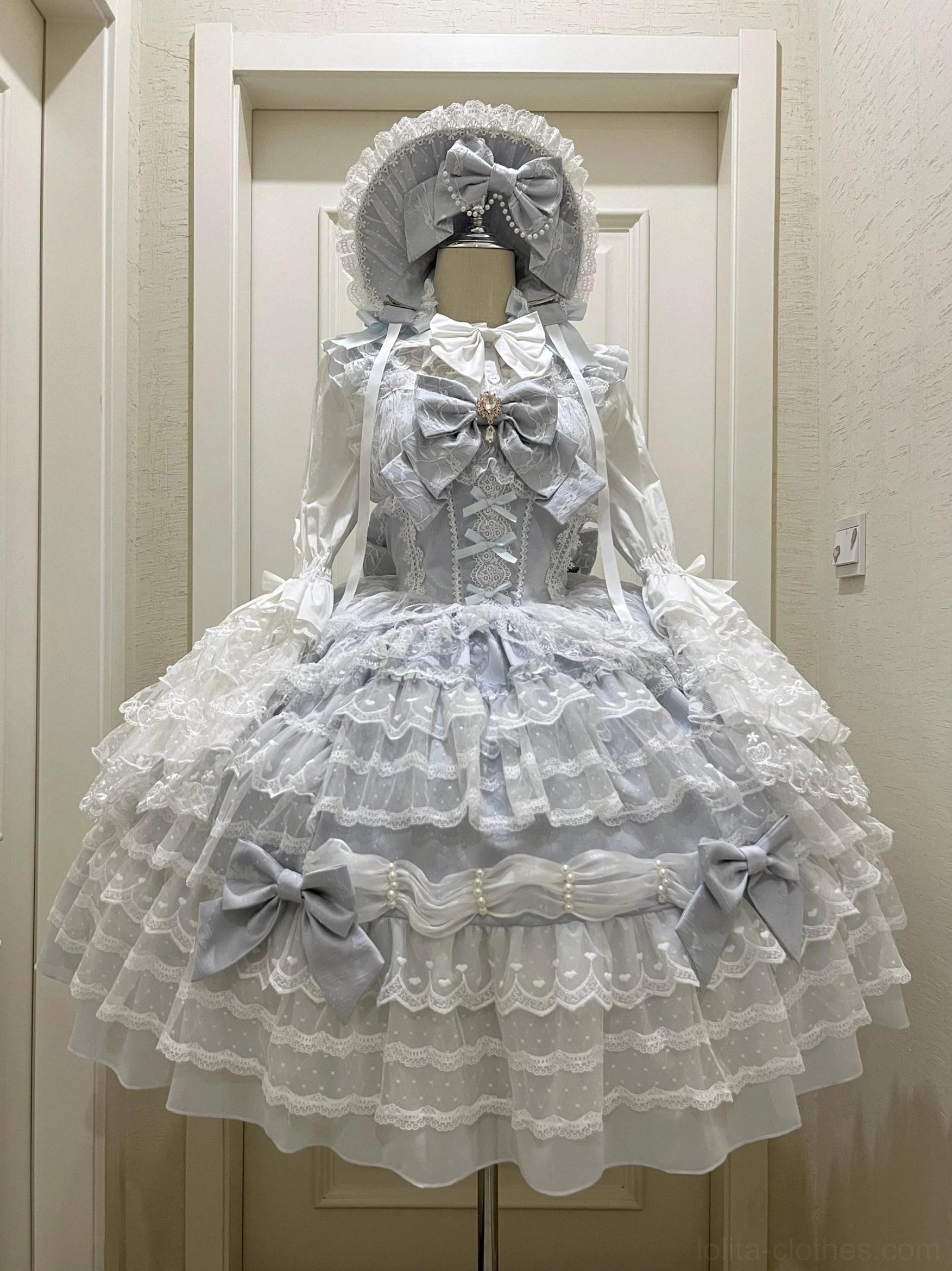 Sky blue dreamy princess Lolita JSK dress set with tiered lace skirt pearl-accented bows corset bodice front view with bonnet