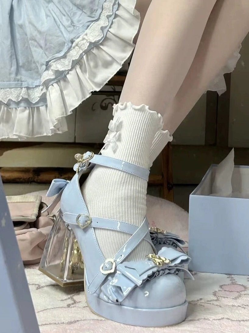 Sweet lolita platform heels showcasing round toe platform design, close-up front view, ruffled bow toe cap embellishment, crisscross ankle strap buckle closure, comfortable rounded toe box lolita silhouette