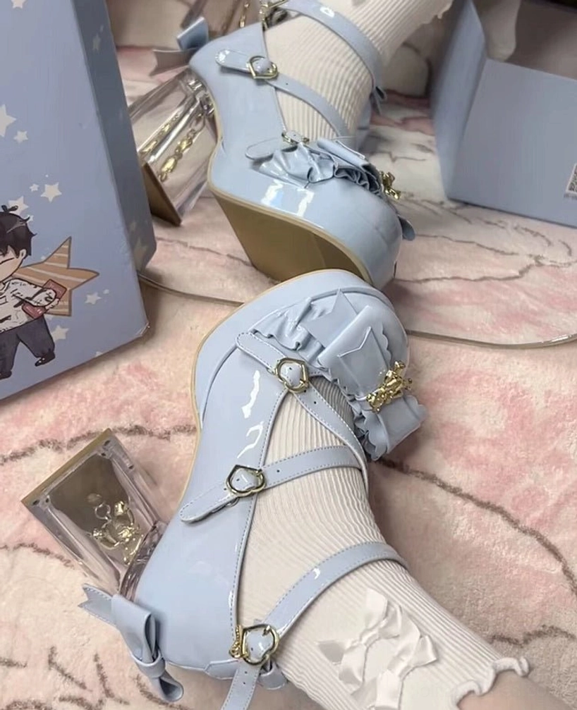 Dreamy bear sweet lolita heels flat lay overhead display showing all angles, crisscross ankle straps with buckle closure, gold hanging bear charm on bow, transparent block heel construction, patent PU leather material