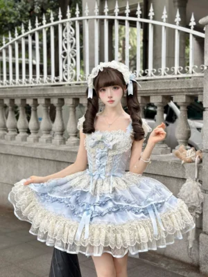 Blue ballet-style sweet lolita jumper skirt front view on outdoor vintage iron balcony, corset bodice, layered lace skirt, white headdress, model lifting skirt hem