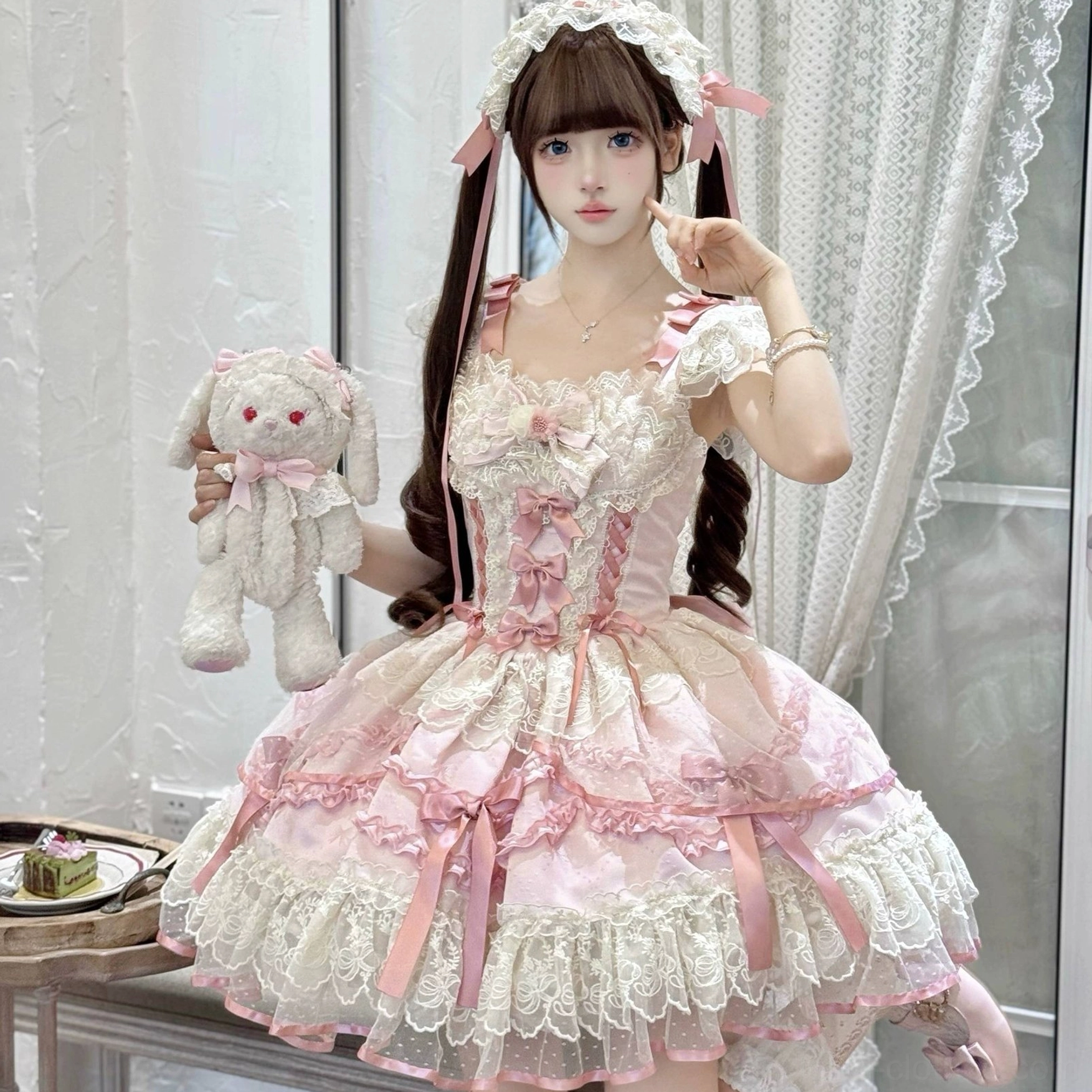 Pink sweet lolita jumper skirt close-up front shot exquisite multi-layered lace trim, front bow decorations, indoor afternoon tea studio, twin-tailed model with plush rabbit prop