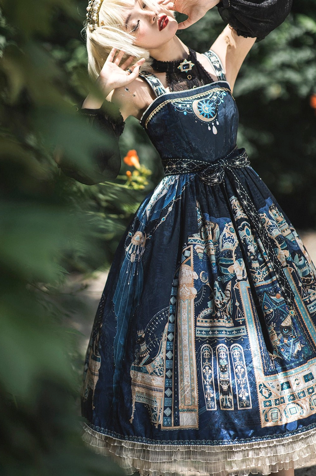 Navy blue Egyptian Lolita JSK overhead angle view showing print distribution waist sash and decorative details