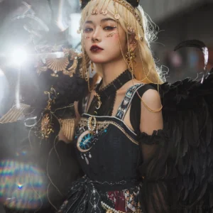 Egyptian lolita slip dress with gold lake blue retro patterns gem brooch black base cold shoulder straps model with feather wings