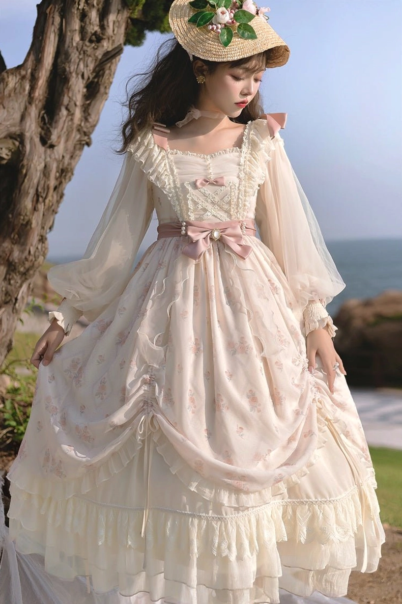 Elegant ivory lolita OP dress front three-quarter shot featuring delicate pink floral prints, fitted bodice with draped fabric, puff sheer sleeves, large pink waist bow, romantic aesthetic
