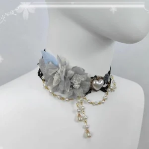 elegant lolita choker necklace grey rose pendant with silver heart gem accent, black lace base, gold pearl chain tassel on mannequin neck close-up