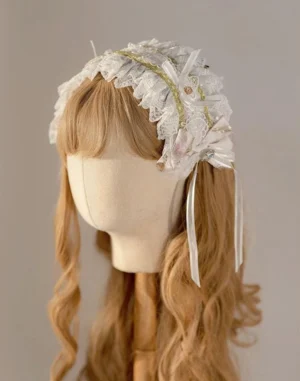 White elegant lolita headdress with ruffled lace, gold stripe trim, satin bows and flowing ribbon embellishments on mannequin