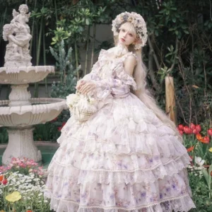 Front full-body view of enchanted garden floral lolita jsk princess dress with off-shoulder ruffled straps and multi-layered ball gown skirt, worn by model in garden with flower wreath