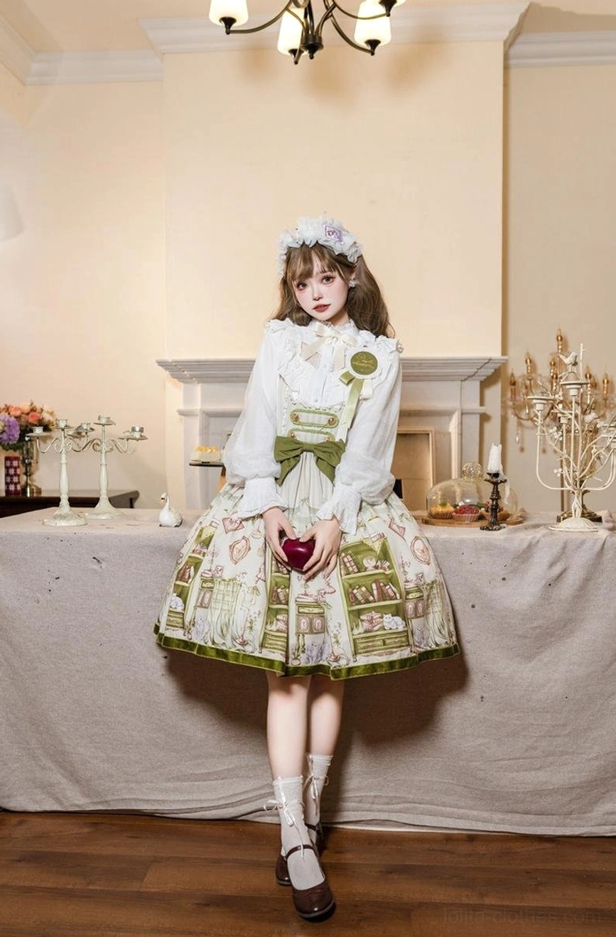 Full-length model wearing Enchanted Library Lolita dress with green bow, holding red apple, vintage tea room with fireplace backdrop and coordinating flower hair accessory