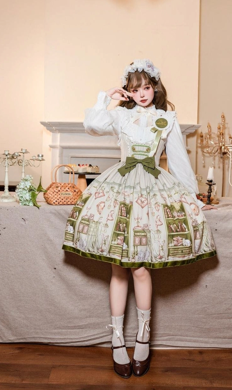 Side-front view of model wearing Enchanted Library Lolita dress set with bookstore print, flower hair accessory, ankle socks and leather shoes in vintage tea room ambiance
