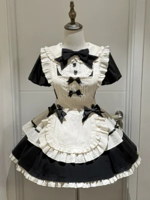 Black and cream enchanted maidette lolita OP dress front flat view on mannequin showing puffy sleeves peter pan collar and ruffled apron with decorative bows