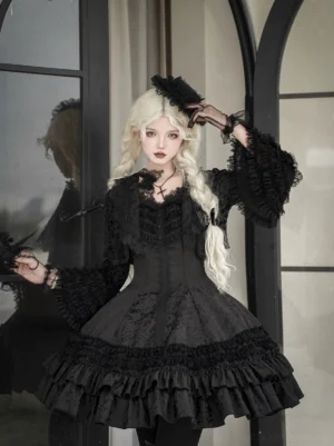 All-black Gothic Lolita JSK dress with tiered ruffled skirt, jacquard fabric, and lace cape collar detail front view