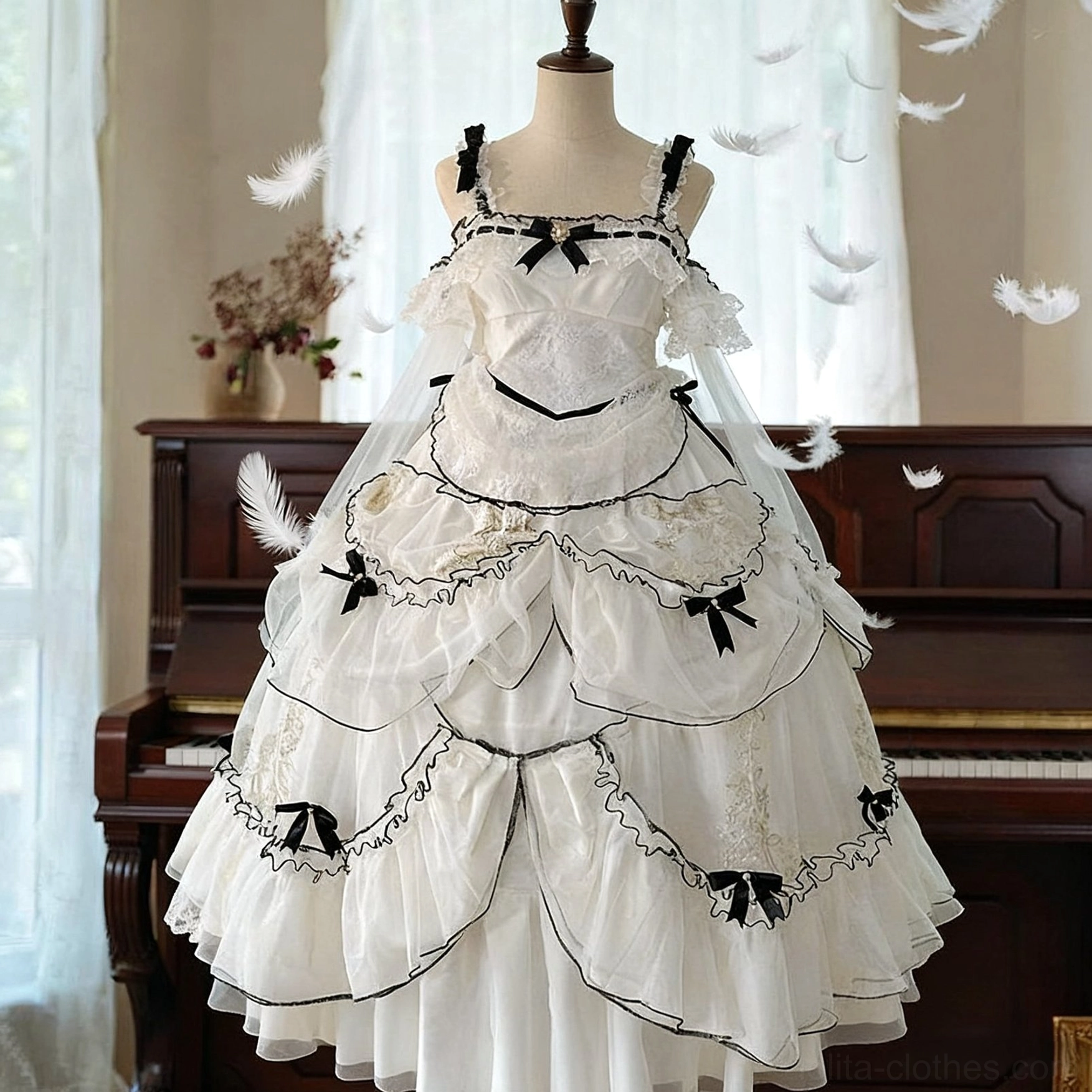 Front full display of ethereal white and black layered sweet lolita JSK dress on mannequin with delicate lace bodice, black satin waist ribbon, multi-tiered tulle skirt and tiny black bows