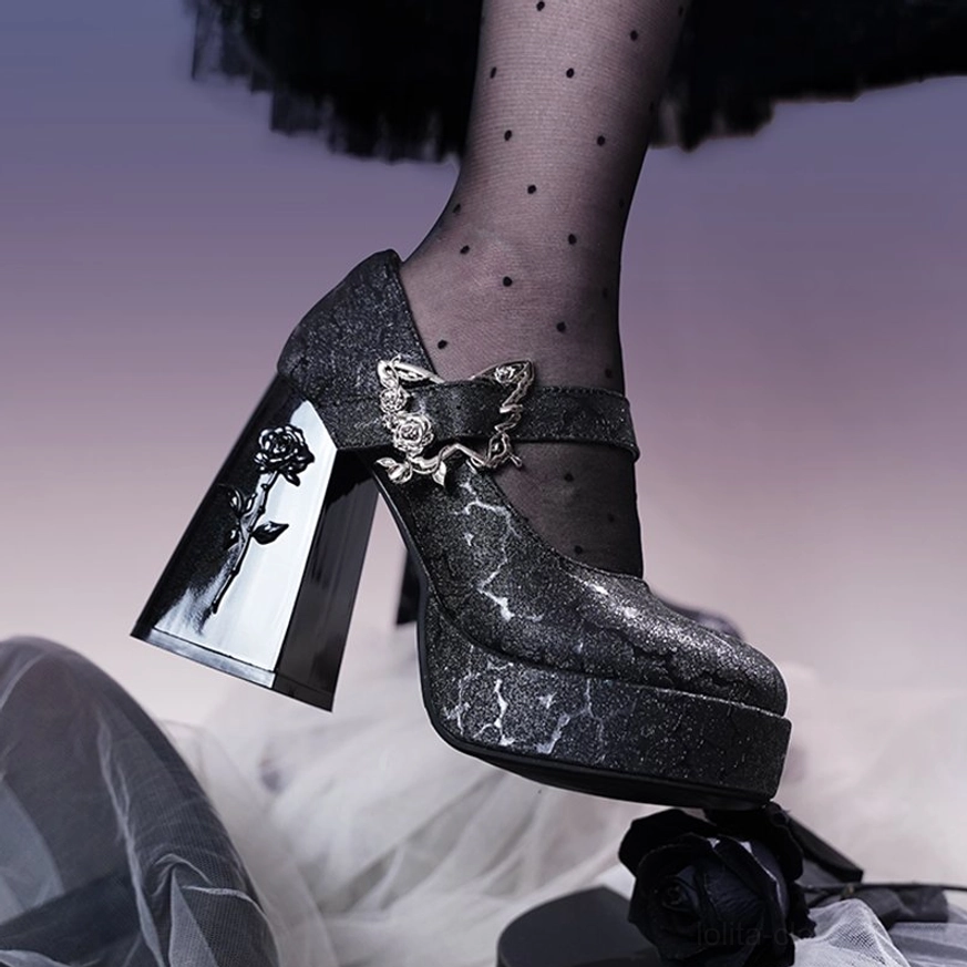 Black glitter cracked texture Mary Jane platform Lolita high heels worn on model's foot with polka dot sheer stockings, showing silver rose-butterfly ankle buckle detail