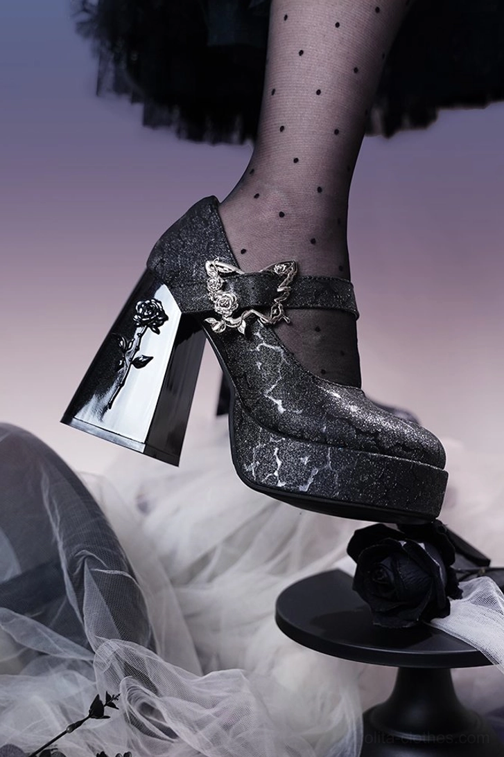 Black glitter textured Mary Jane platform Lolita heels with side profile showing cracked glitter finish, rose-embossed heel, and silver butterfly buckle on polka dot stocking foot