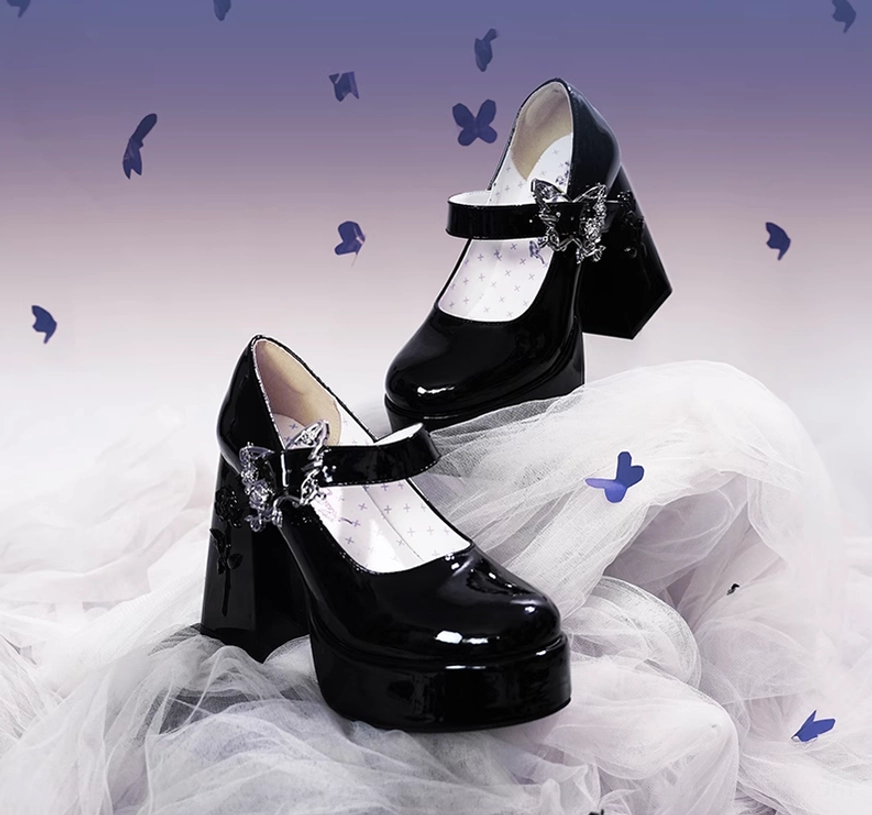 Glossy black patent leather Mary Jane platform Lolita heels with thick platform and block heel, floating display with tulle fabric, butterflies, and purple gradient background