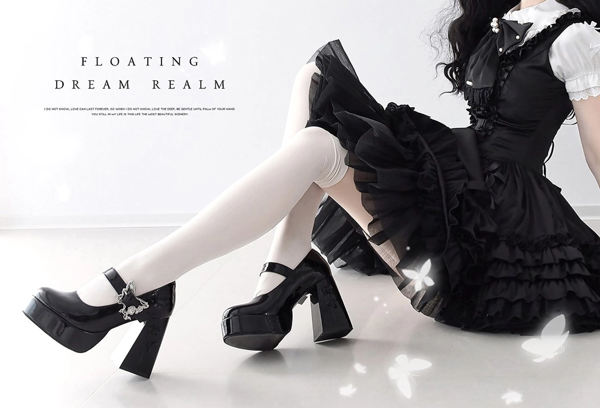 Black Mary Jane platform Lolita heels with silver butterfly-rose buckle on model wearing gothic lolita ruffled black dress and white thigh-high stockings