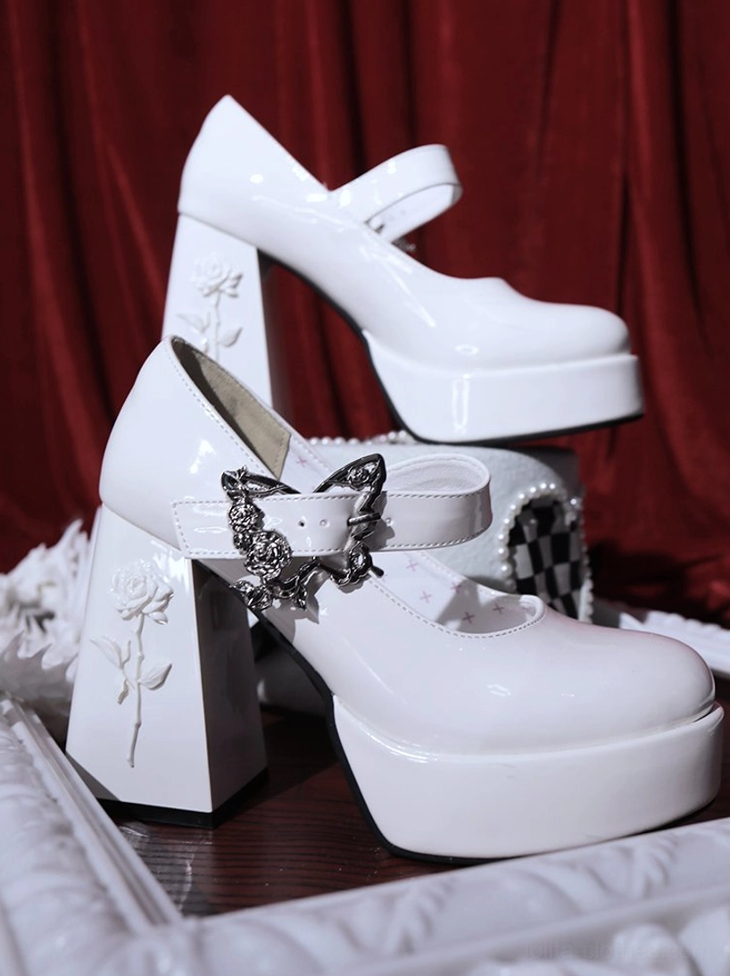 White Mary Jane platform Lolita heels showcasing pristine patent leather finish with silver butterfly buckle and sturdy block heel structure