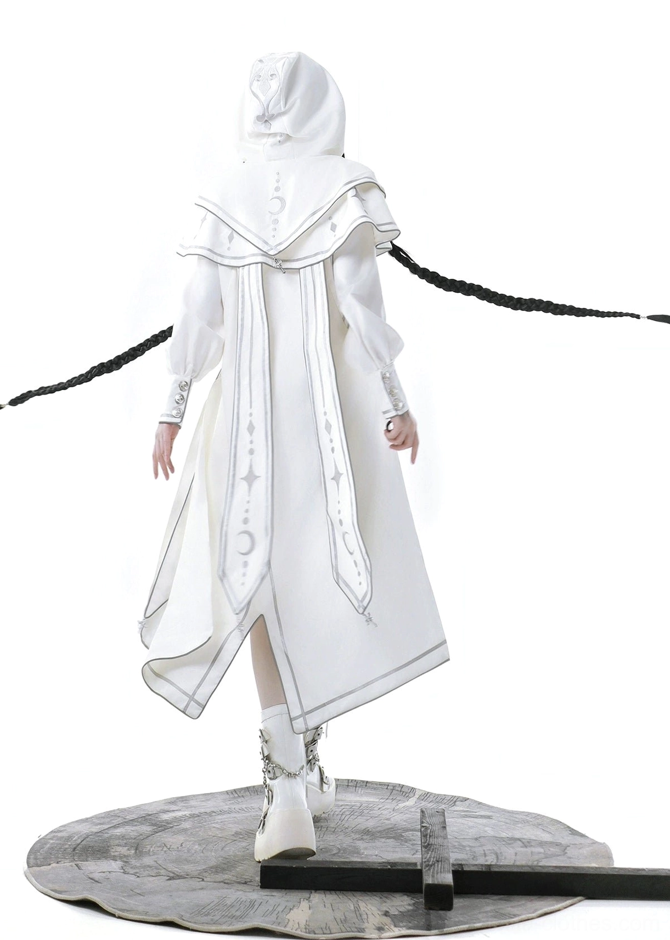 Full rear standing view of complete white lolita ensemble on vintage display base showing hooded cloak back detail, silver decorative stitching along all garment edges, celestial embroidery