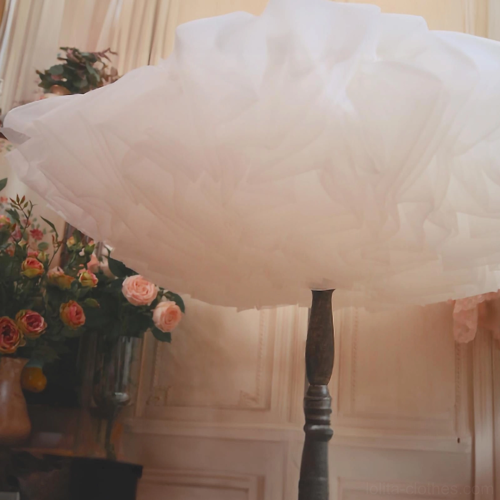 Close-up overhead view of ultra-fluffy white tulle petticoat skirt, showing dense layered structure and premium organza fabric quality for volume