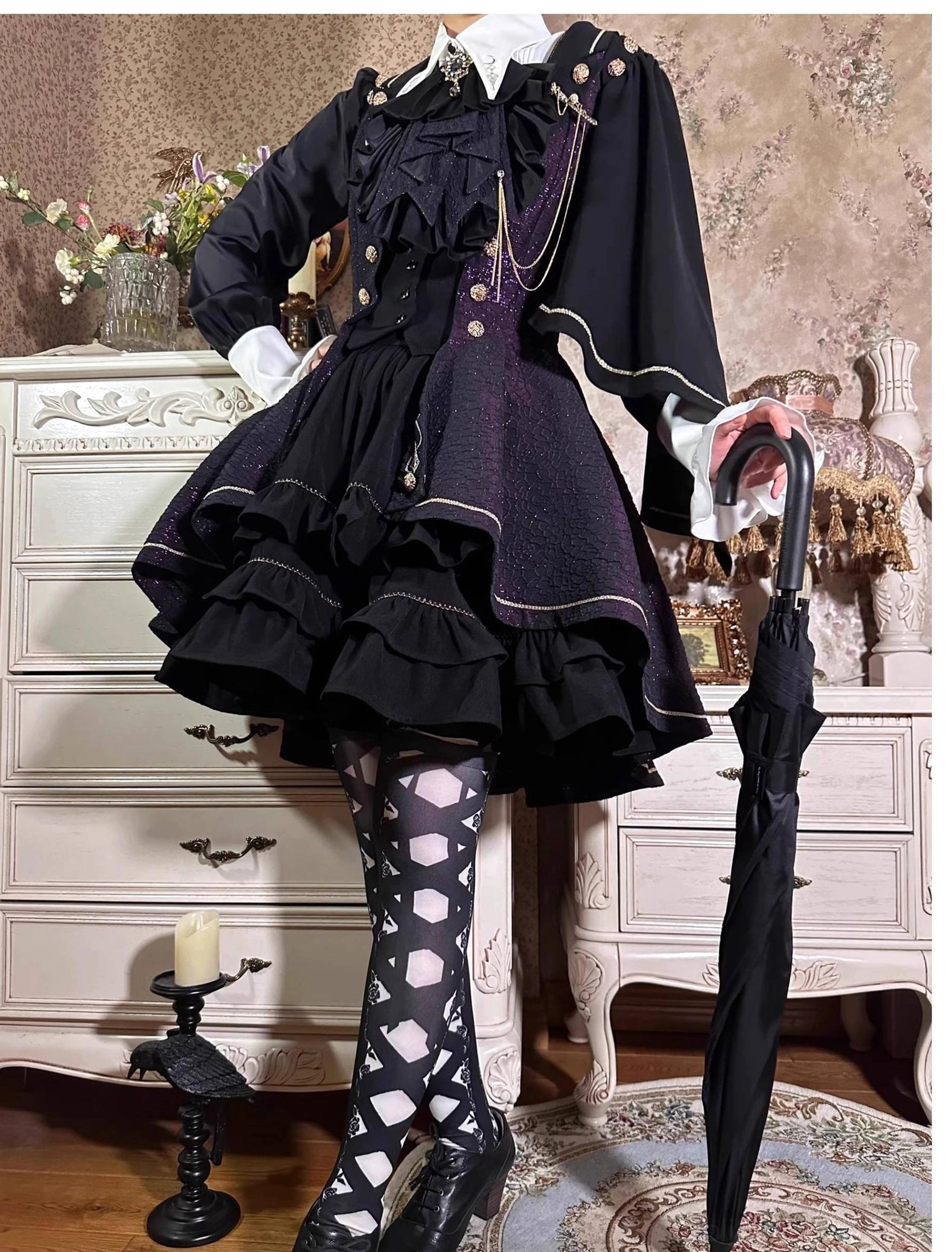 Fallen Moon Rule dark purple retro military lolita dress set, full-body standing display in vintage indoor scene, model wearing polka-dot tights and high heels, holding black folding umbrella, featuring ruffled front placket and layered skirt