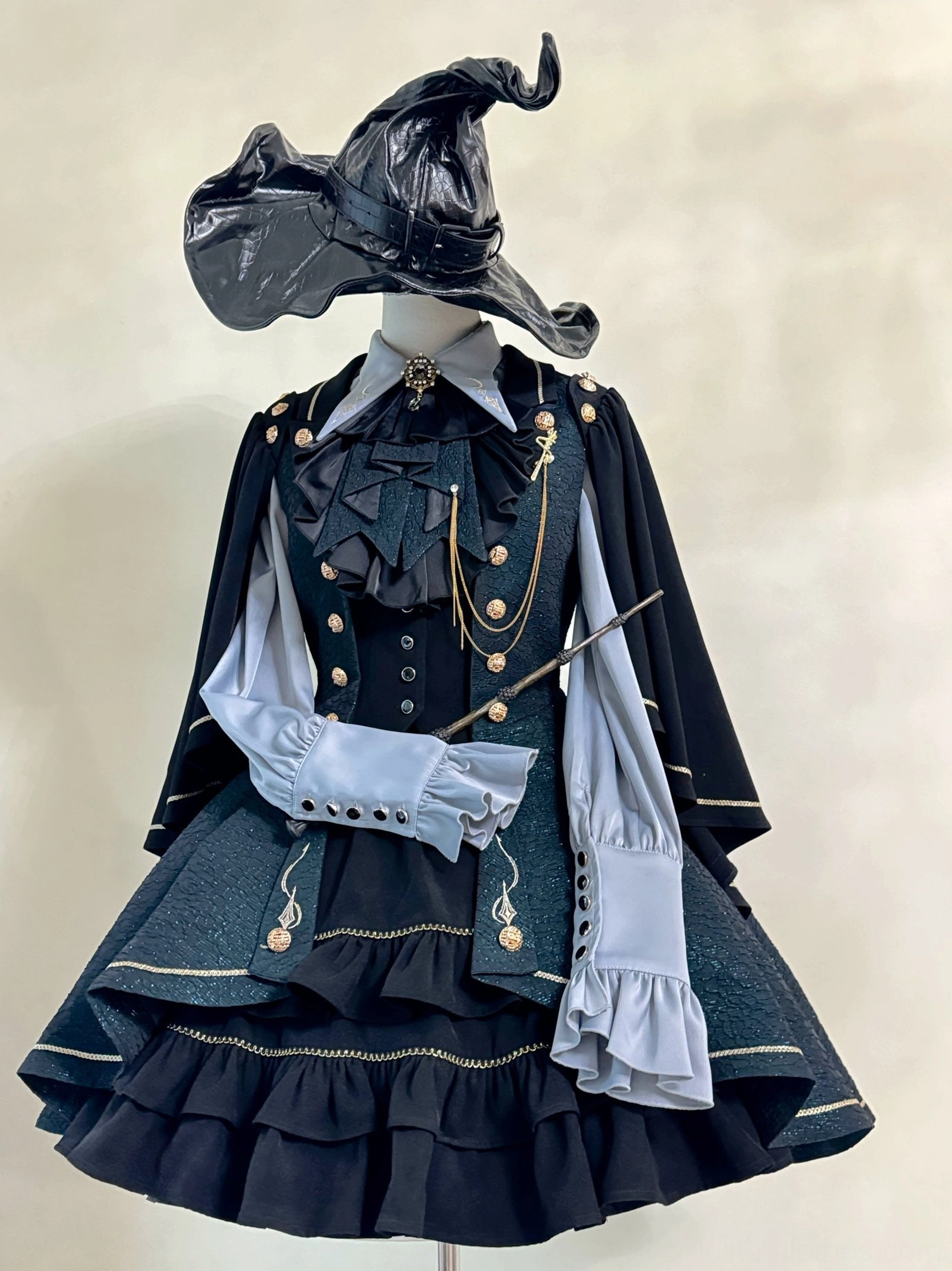 Fallen Moon Rule military lolita skirt detail close-up, highlighting tiered ruffle layers, scalloped edging, black underskirt structure, and gold trim embellishment