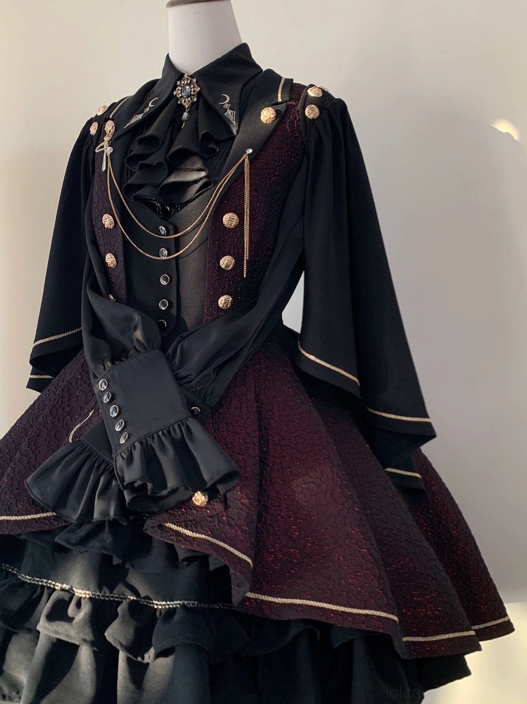 Fallen Moon Rule military lolita sleeves close-up detail, displaying ruffled cuffs, flared sleeve construction, and detachable cape sleeve connector mechanism
