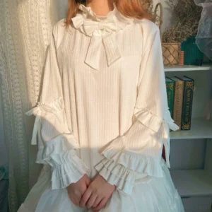 First snow sweet lolita knit inner blouse with beige color featuring ruffle round collar and tiered puff sleeves in close-up front view with bow decoration