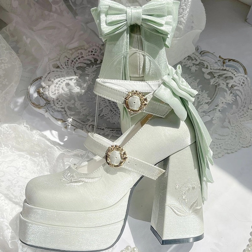 Light green lolita platform heels with metallic finish and lily embroidery details, showcasing the delicate botanical-inspired design elements of the floating dream collection