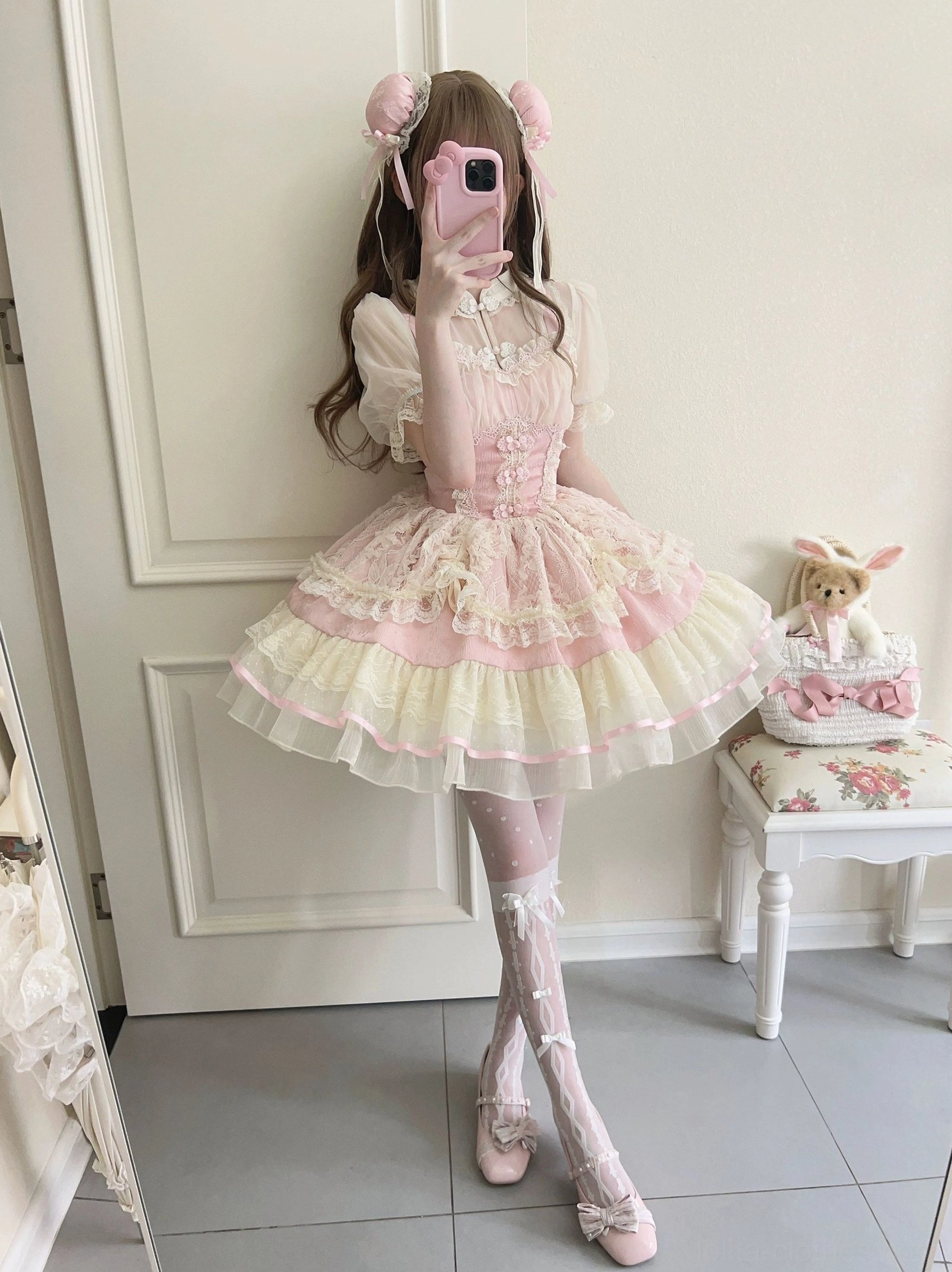 Pink cream lolita ballet jsk dress back view showing fitted waist corset and ruffled tiered skirt with ribbon trim detail
