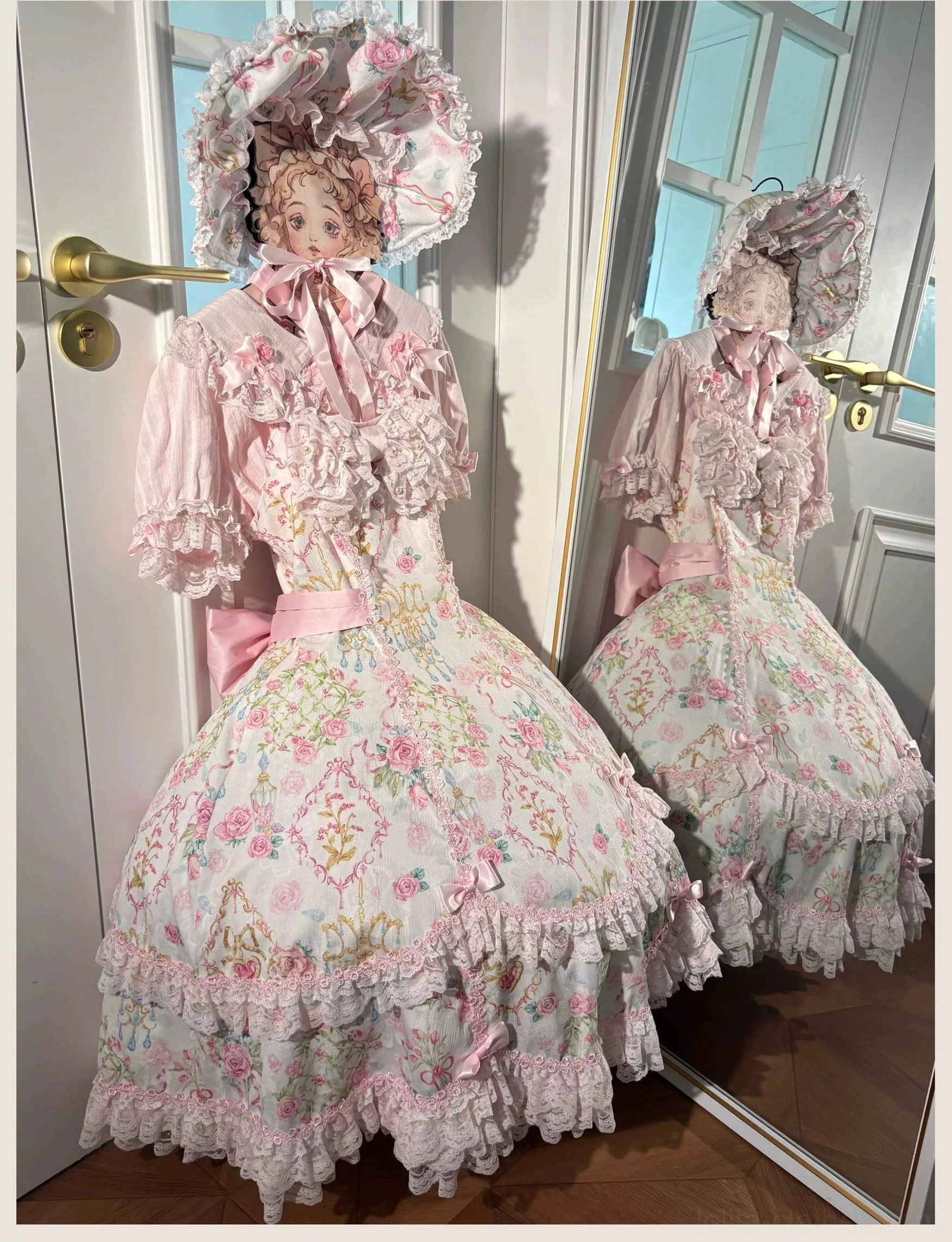 Floral Lolita JSK dress displaying layered ruffled skirt hem with pink lace trim and bell silhouette construction