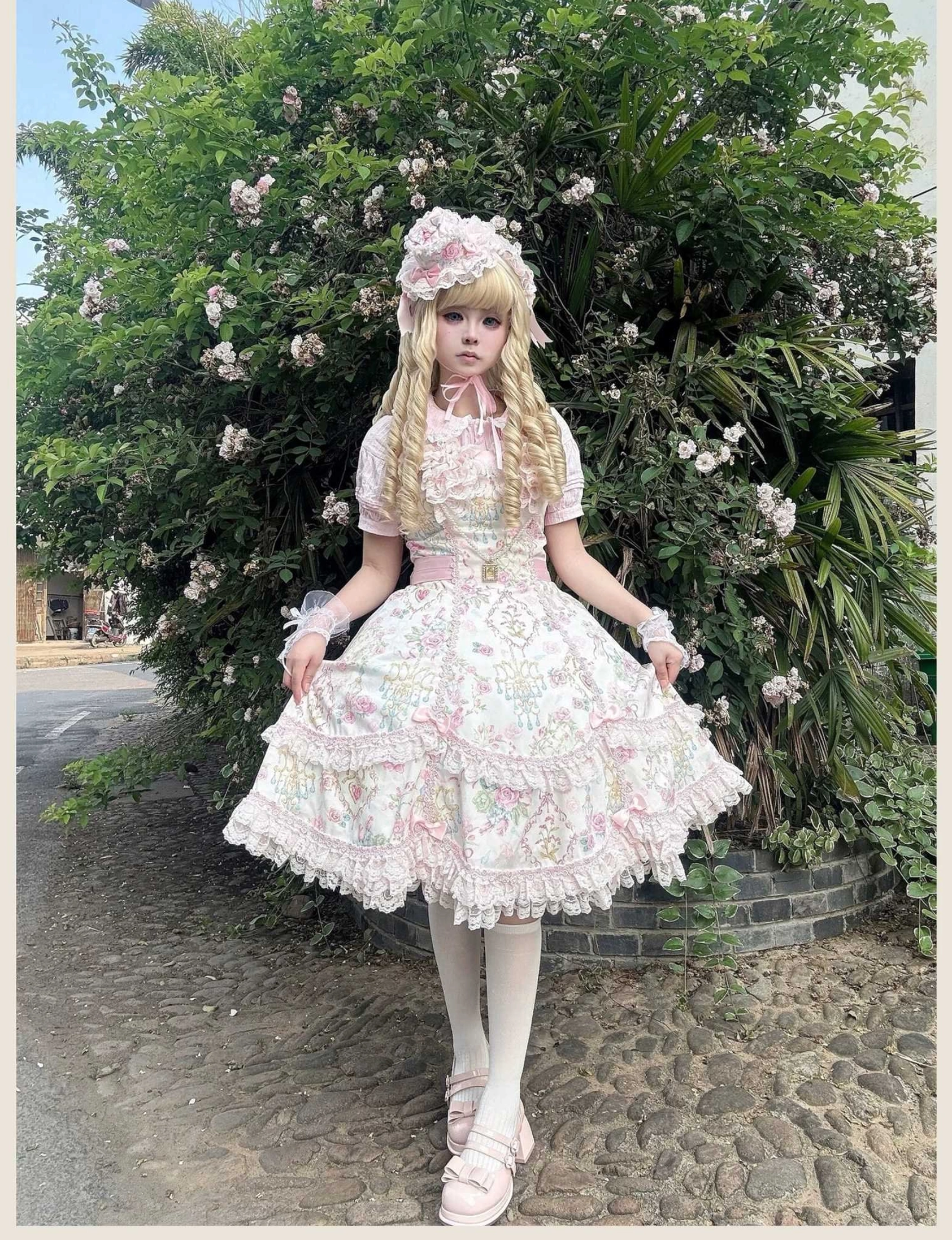Floral Lolita JSK dress with short-sleeve inner shirt, lace-trimmed sleeves and layered ruffled skirt shown in three-quarter side view