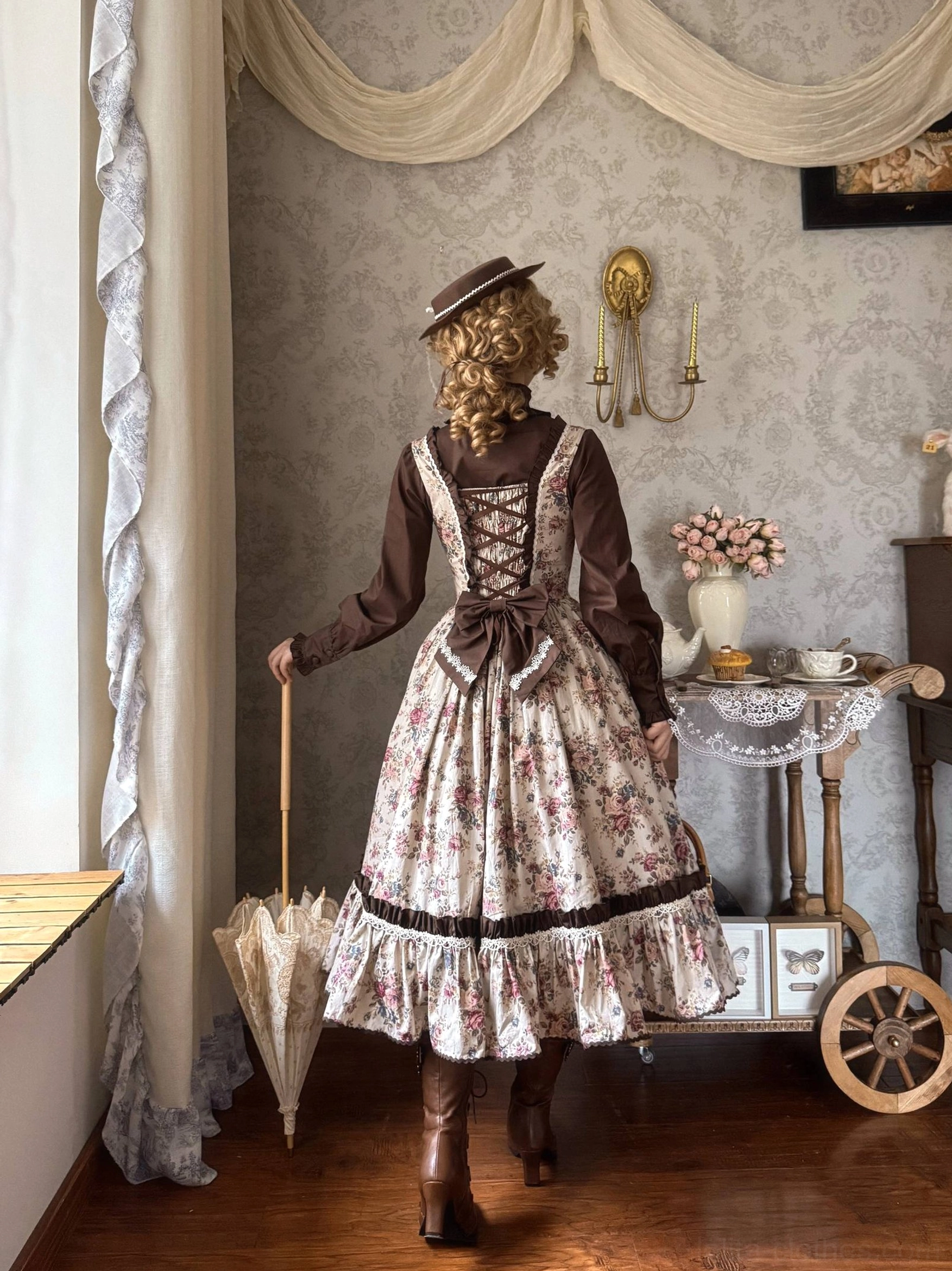Floral Reverie Old School Lolita JSK back view on model showing corset lace-up design printed skirt flounce hem and vintage umbrella prop