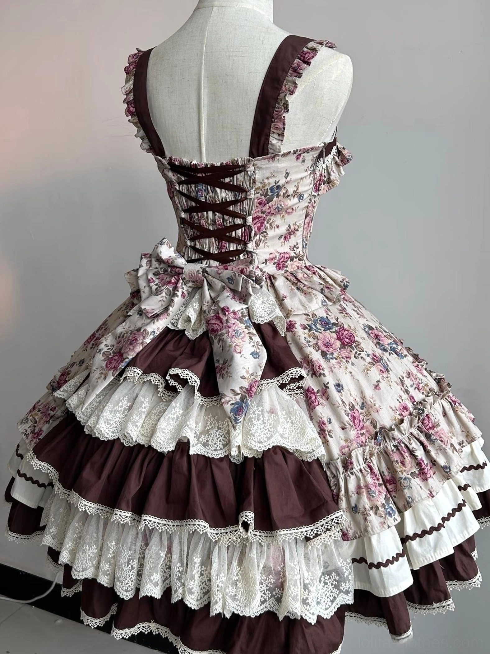 Floral Reverie Old School Lolita JSK back view on mannequin showing corset lace-up back closure detachable bow and brown ruffled hem trim